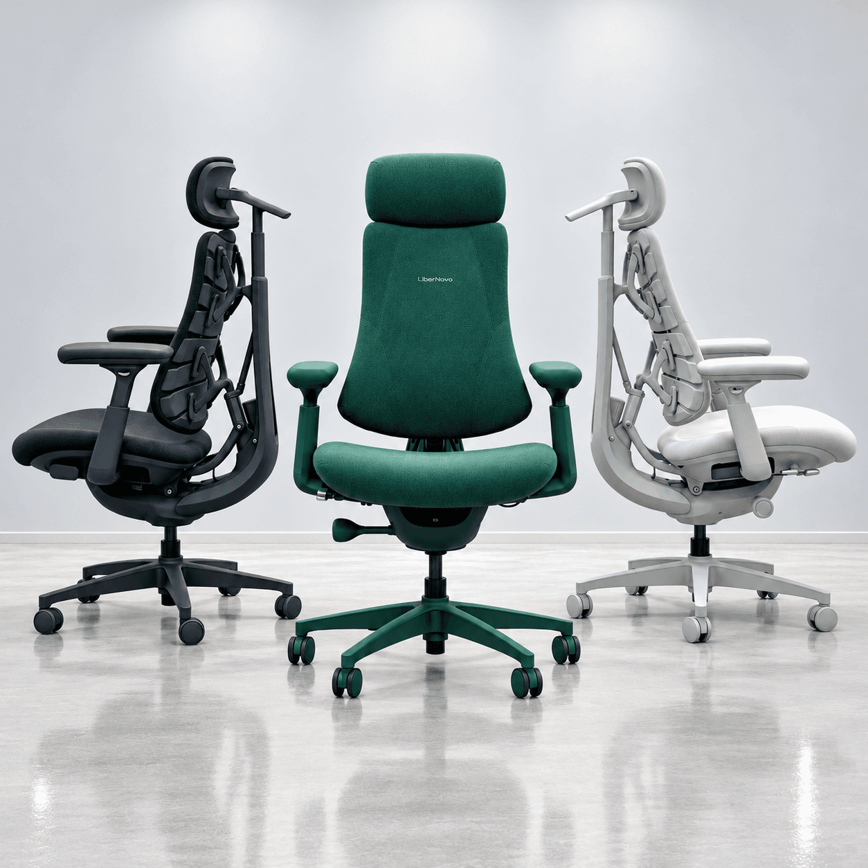 Three LiberNovo ergonomic chairs in dark, green, and light finishes